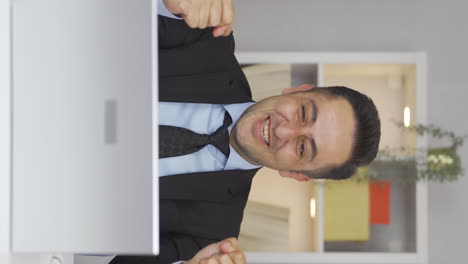 Vertical-video-of-Home-office-worker-man-experiencing-joy.